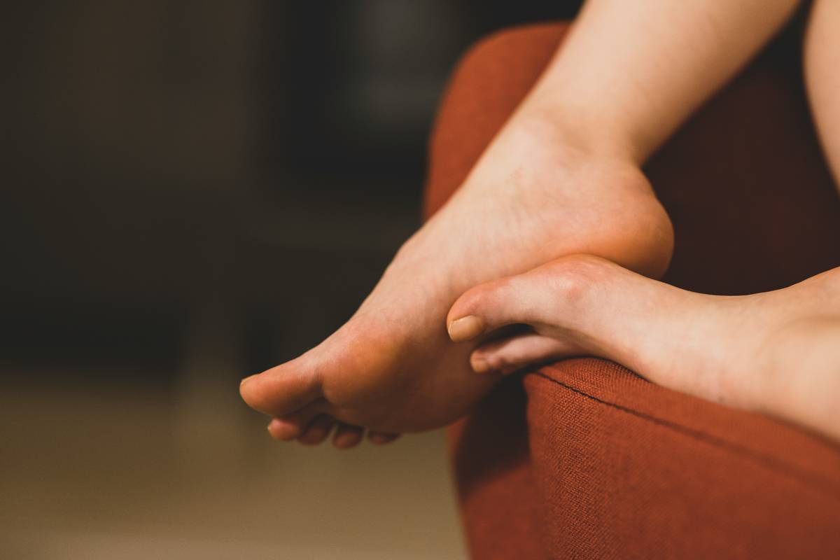 Infographic showing foot zones needing care: heels, balls of feet, cuticles, and ankles with hydration/exfoliation icons